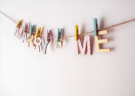 Words marry me, on a white background, the concept of Valentine's Dayengagementの写真素材