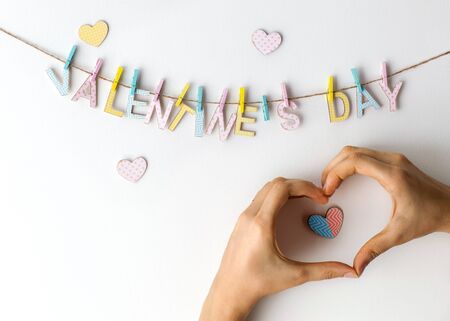 Valentines Day Heart from hands on a white background hanging wordsの写真素材