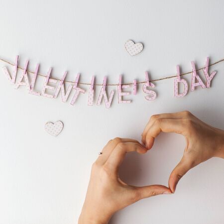 Valentines Day Heart from hands on a white background hanging wordsの写真素材