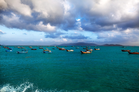fishing boats on the sea, on a background of mountainsの写真素材