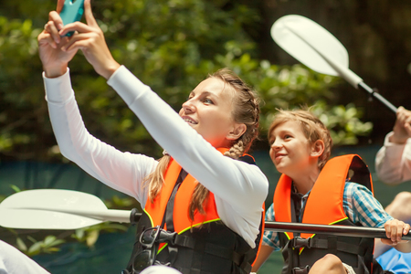 family kayaking and makes selfieの写真素材
