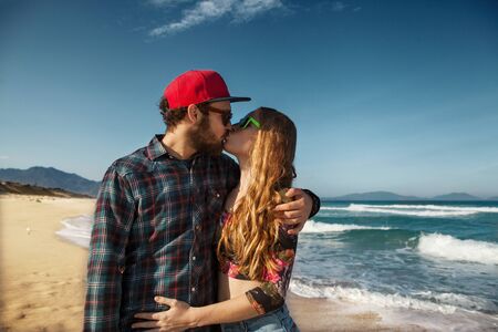 couple in love on the sea playing happily at sunsetの写真素材