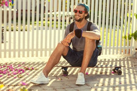 guy skateboard at sunset from his garden penthouseの写真素材