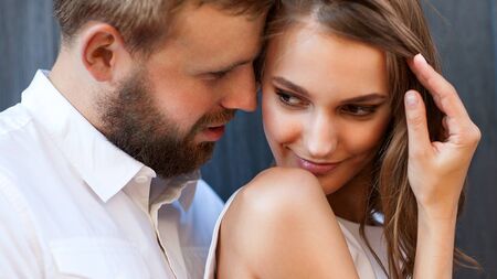 fashion couple standing in the European quarter, in a white dress, posing love at sunset.