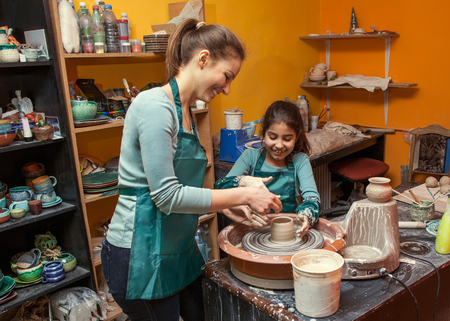 mother and daughter mold with clay, pottery children