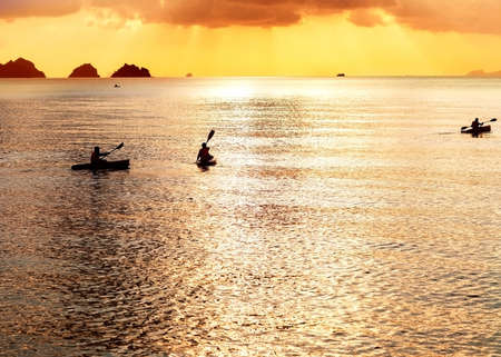 Three kayak float at sunsetの写真素材