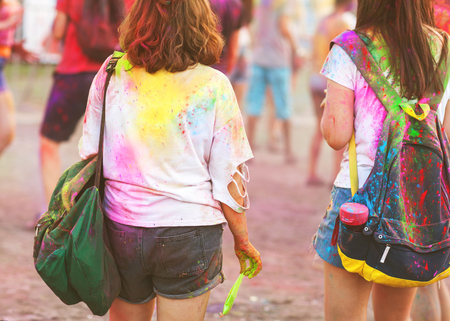 two girl celebrating the Holi festival at sunset