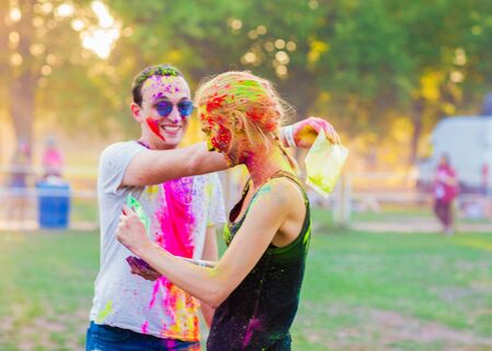 Guys with a girl celebrate holi festivalの写真素材