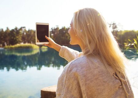 girl in an autumn park near a lakeの写真素材