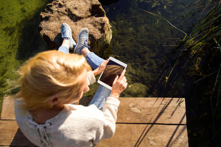 girl in an autumn park near a lakeの写真素材