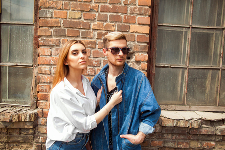 fashion girl with a guy on the street posing on a green wooden backgroundの写真素材