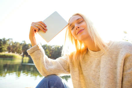 girl in an autumn park near a lakeの写真素材