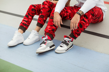 fashion guy with a girl posing sport styleの写真素材