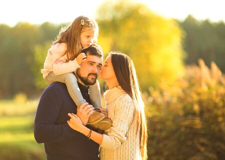 Family playing in autumn park having funの写真素材