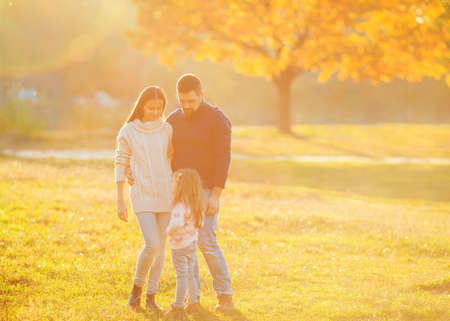 Family playing in autumn park having funの写真素材