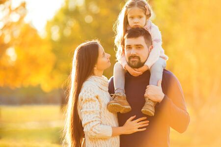 Family playing in autumn park having funの写真素材