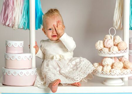 beautiful baby girl sitting near the fabulous marshmallow houseの写真素材