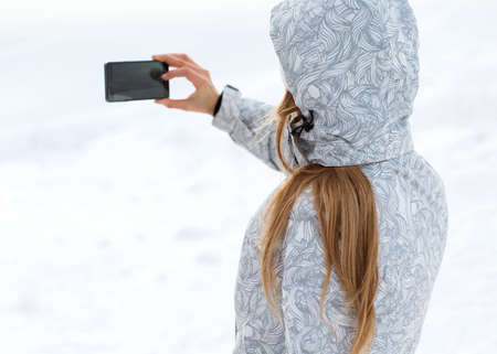 tourist makes selfies on a high mountainsideの写真素材