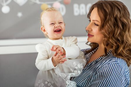 Mom and daughter are at home in the room, Mother's Day.