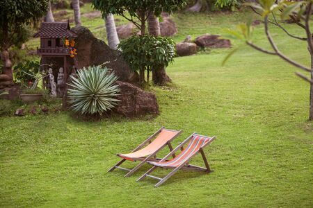 beach loungers in the mountains between tropical palms in Thailand