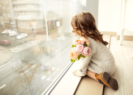 A little girl with a bouquet of flowers on her mother's day.の写真素材