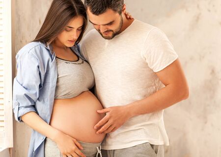 couple in love pregnant cuddling, waiting for babyの写真素材