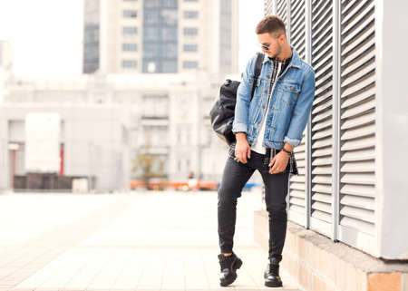 fashion guy posing in sunglasses on sunset