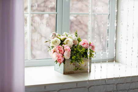 Window with curtains and flowersの写真素材