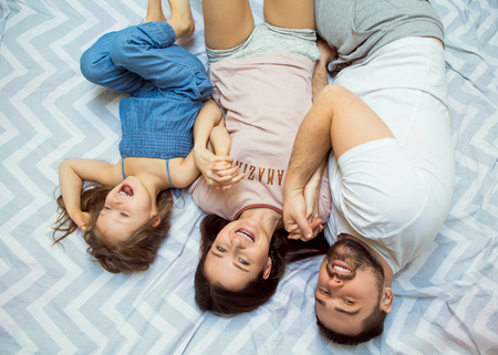 family with daughter having fun at home, the concept of a happy family.