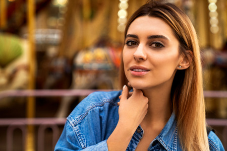 portrait of a girl in American style on a swing laughs and rejoicesの写真素材
