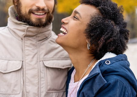 Couple in love are walking in the autumn park. Afroamerican girl with a European.のeditorial素材