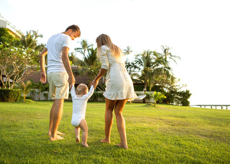 Family walk in the park, happy at sunset in Samui, Thailandの写真素材