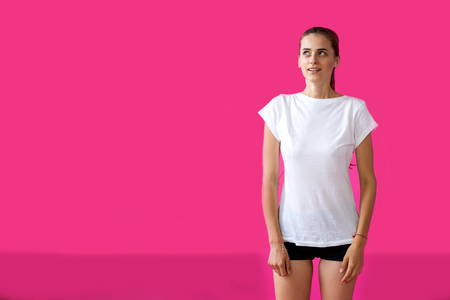 girl sportsman posing on a pink backgroundの写真素材