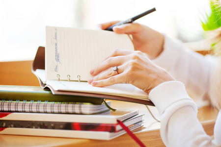 girl freelancer working in the office on notebookの写真素材