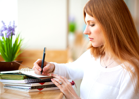 girl freelancer working in the office on notebookの写真素材