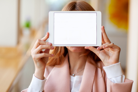girl freelancer holding a tablet in the officeの写真素材