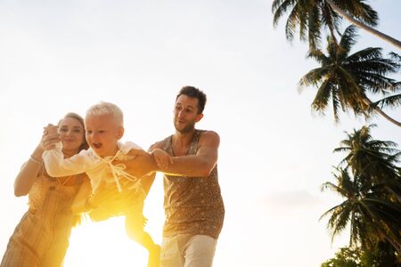 happy family playing at sunsetの写真素材