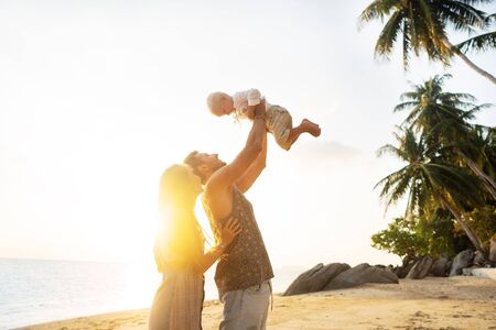 happy family playing at sunsetの写真素材