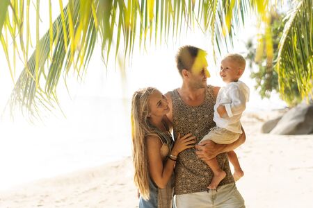 happy family in love on the beach at sunsetの写真素材