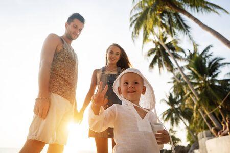 happy family in love on the beach at sunsetの写真素材