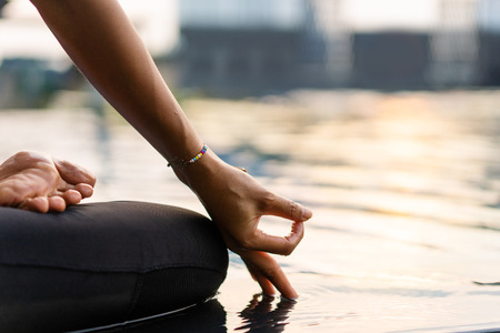 girl doing yoga at sunset in Thailand near the poolの写真素材