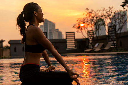 girl doing yoga at sunsetの写真素材