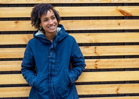 beautiful african girl in autumn park outdoors smilingの写真素材
