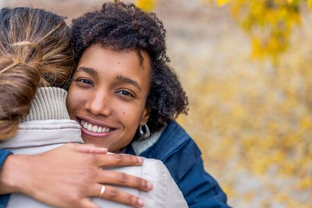 guy with an african  girl in love in autumn park walk at sunset