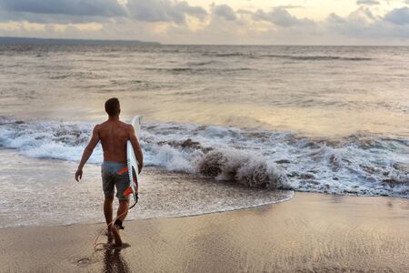 partner surfer at sunset by the ocean in Baliの写真素材