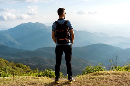 tourist guy stands on the edge of the mountains in thailandの写真素材
