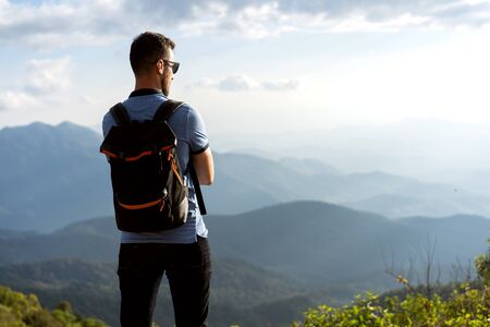 tourist guy stands on the edge of the mountains in thailandの写真素材