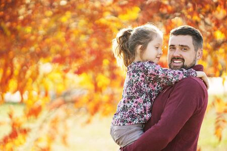 dad with his daughter in the autumn park walksの写真素材