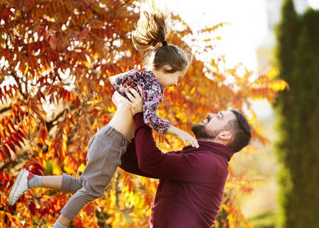 dad with his daughter in the autumn park walksの写真素材