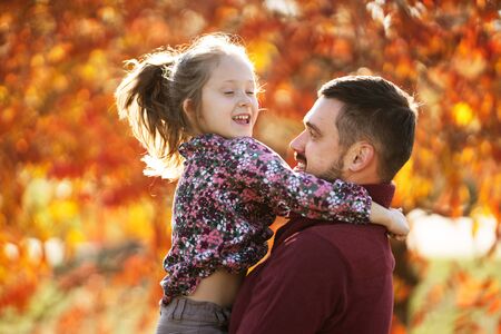 dad with his daughter in the autumn park walksの写真素材